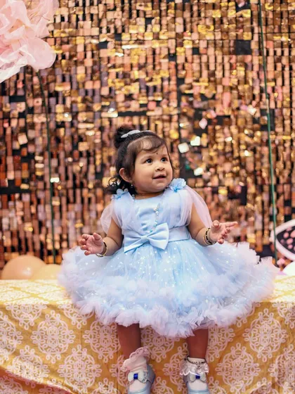 The pure joy of a first birthday party. We love capturing the vibrant colors, fun decorations, and the birthday girl's delightful expressions against a sparkling backdrop during our kids' photography sessions.