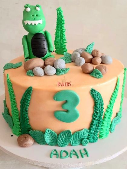 A dinosaur cake for little Adah, who loves everything about dinosaurs. This minimal-fondant cake features a cute T-Rex and lots of green foliage. The flavor was vanilla with fresh mangoes.