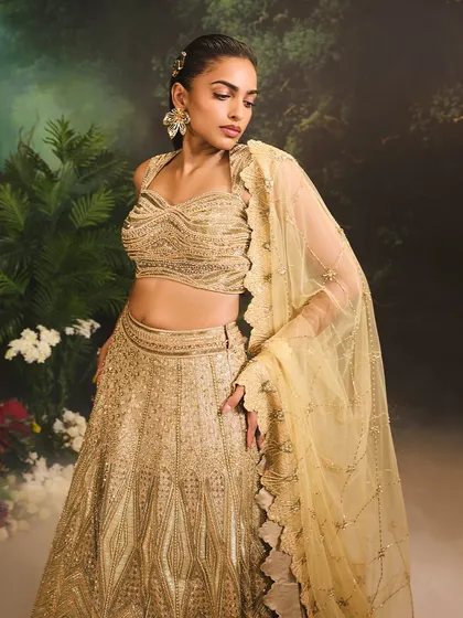 The Jade Lehenga Set, a vision in gold. The intricately adorned blouse and flowing lehenga are designed for weddings and festive celebrations alike.