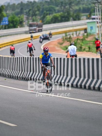 The peloton, a colorful and dynamic sight, races down the highway.