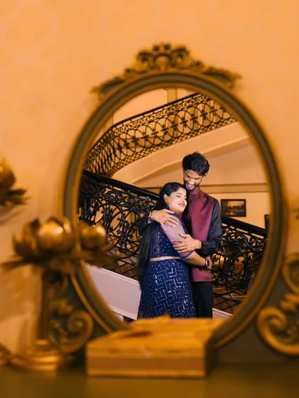 A beautiful reflection shot, capturing the couple's embrace in a mirror. This adds a creative and intimate touch to your pre-wedding album.