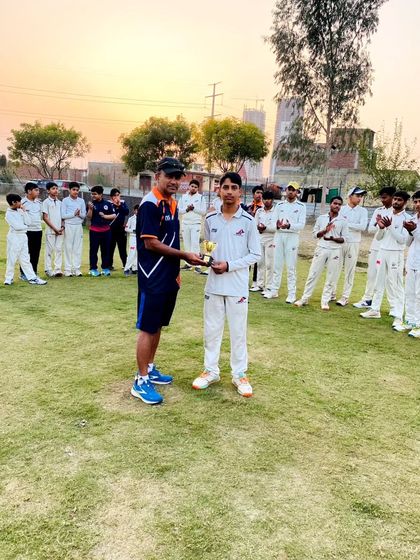 The whole team applauds as the best batsman receives his award. We foster a supportive environment where everyone celebrates each other's success.