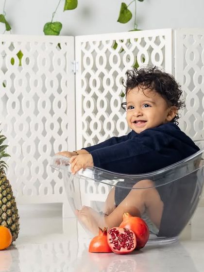 Getting ready for the splash. Even before the water is added, the excitement is building in this fun and colorful fruit-themed setup.