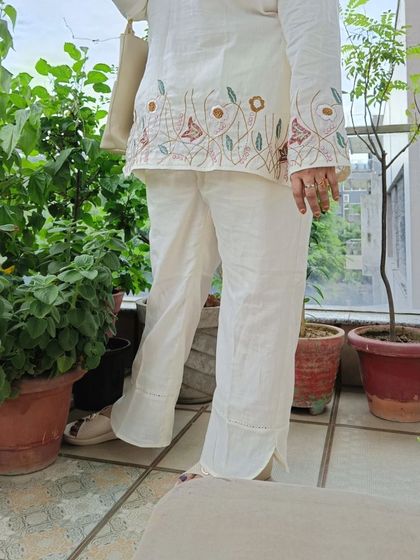 A view of the embroidered pants from our linen co-ord set, showing the delicate details and relaxed fit.