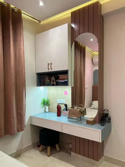 This is an example of my multi-functional furniture design in a Jasola residence. This compact unit serves as both a study desk and a dressing table, complete with an integrated mirror, task lighting, and overhead storage, making it ideal for optimizing space in a bedroom.