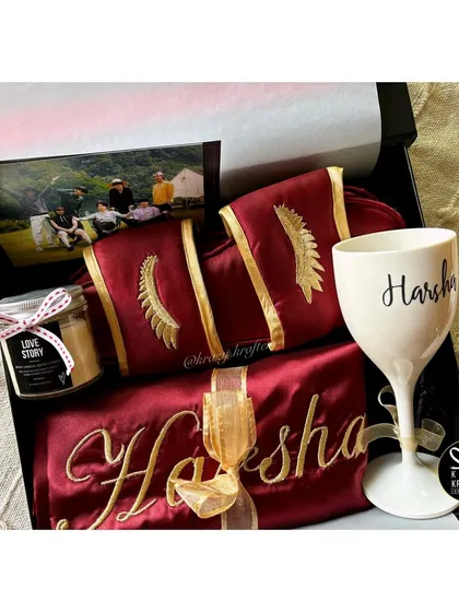 The ultimate luxury experience for the bride-to-be. This hamper features a personalized satin robe and slippers, a custom wine glass, and a 'Love Story' scented candle.