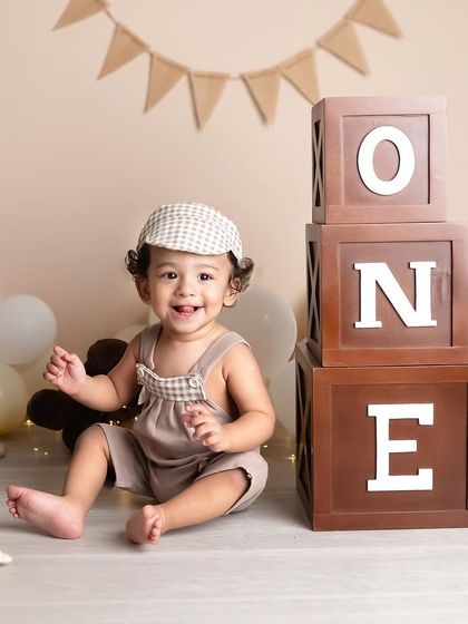 Such a happy smile from this little guy celebrating his first birthday. The classic setup with wooden blocks and a simple banner is timeless and focuses on his personality.