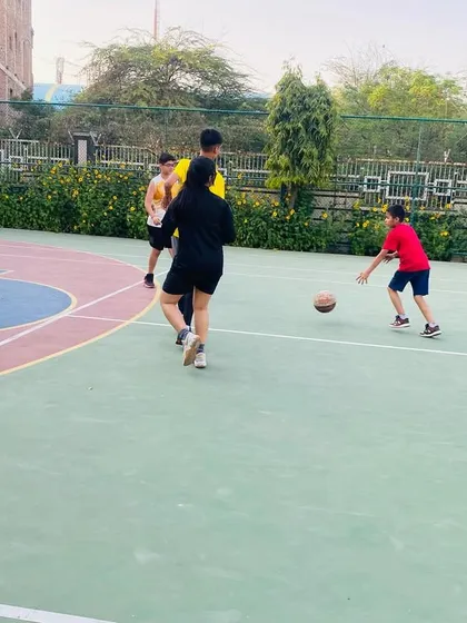 A young player practices dribbling while keeping his eyes on the court.