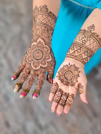 A creative take on a mandala design, with one hand fully adorned and the other featuring a simpler, complementary pattern.