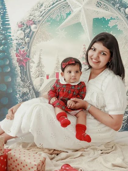 A sweet Christmas moment with Mamma. This portrait of a mother and her baby girl in their winter wonderland set is simply precious.