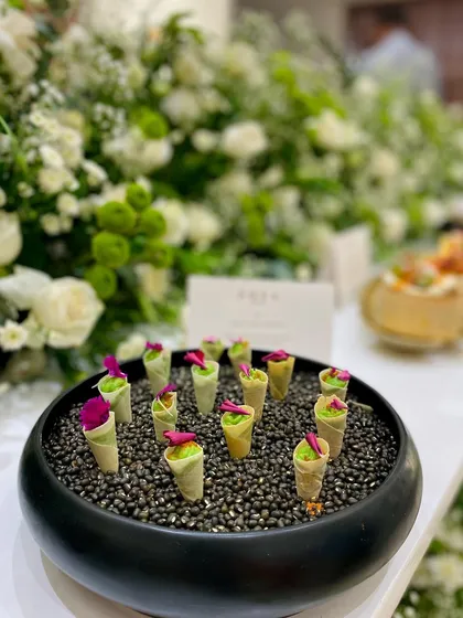 Our Edamame & Truffle Cones, elegantly presented on a bed of black lentils for a visually striking display at the Zoya Jewels event in Hyderabad.
