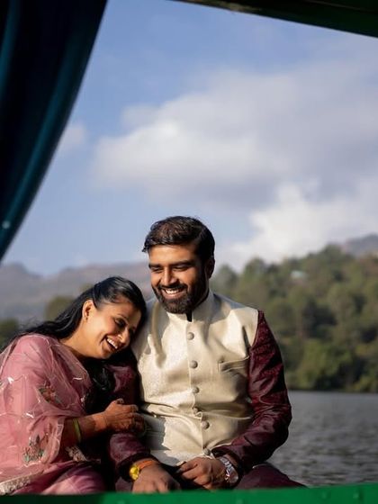 A tender moment with the bride resting her head on the groom's shoulder during a boat ride on the lake.