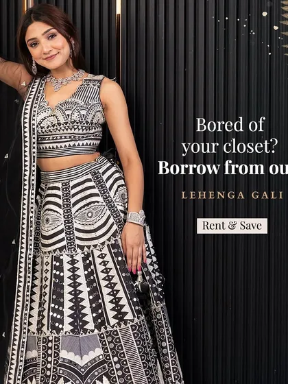 Stand out from the crowd with this unique black and white lehenga featuring bold geometric patterns and mirror work. It's a contemporary take on traditional wear, perfect for a fashion-forward guest at a wedding reception or cocktail event.