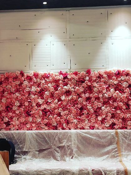 This is an artificial pink rose flower wall I was setting up for an event. These make for a very popular photo backdrop at weddings, birthday parties, and bridal showers.