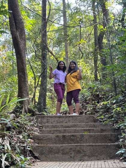 Two trekkers on the steps leading to the falls.