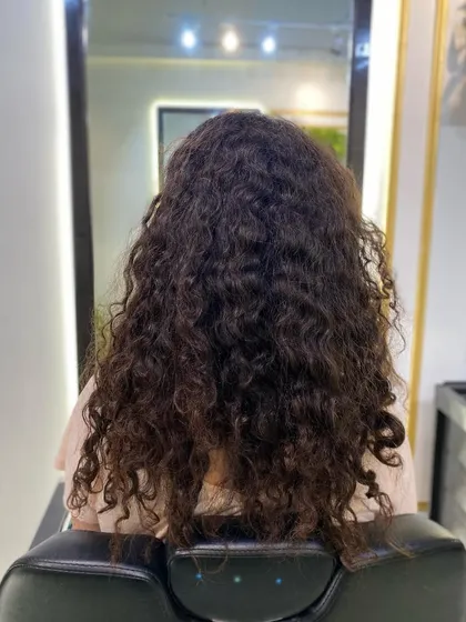 This client from France came in with dry, undefined curls. After a deep conditioning treatment and a precision haircut, her hair was revitalized, hydrated, and full of life.