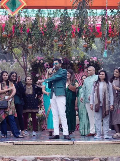 Addressing the family on stage, explaining the next fun activity. Clear communication and high energy are crucial.