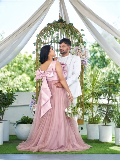 This photo showcases the beautiful back of the 'Bloom' gown, featuring a large, elegant bow that adds a surprising and delightful detail. It's perfect for photos from every angle.