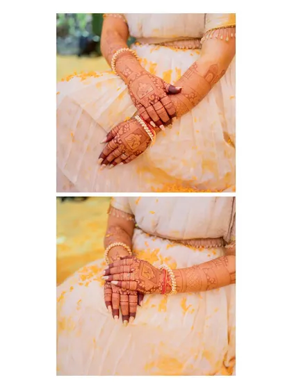 A close-up of the bride's hands during her Haldi ceremony, showing her detailed mehndi design lightly dusted with turmeric.