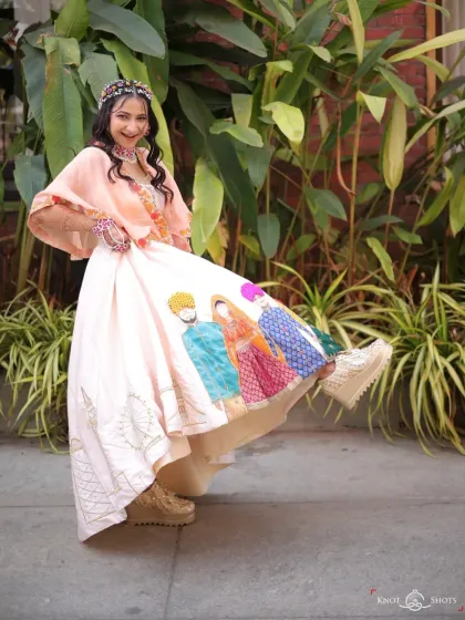 A fun and quirky Haldi look. This bride's custom lehenga tells her love story, and she paired it with cool platform sneakers. The makeup is fresh and playful to match.
