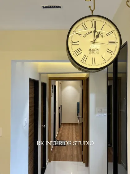 Details matter. This antique-style hanging clock adds a touch of vintage charm to the modern living room corridor.