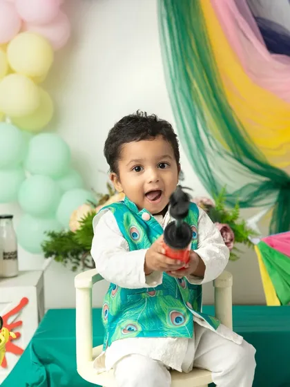An excited shout of "Holi Hai!" from this little boy, ready for the festival of colors.