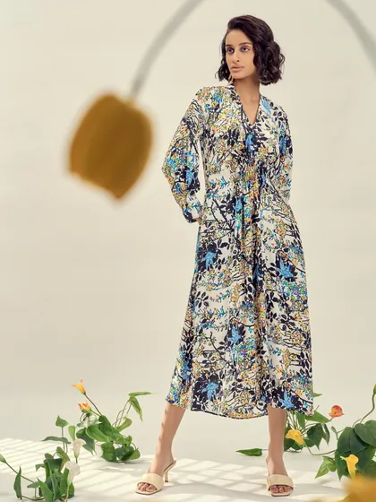 A long, flowing printed dress styled for a brand's lookbook. The relaxed silhouette and artistic print make it a perfect example of wearable art.