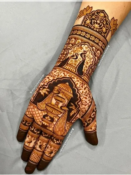A rich design featuring a peacock and a fountain on the palm. The wrist is adorned with another peacock in a jharokha, creating a cohesive and elegant theme.