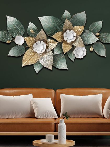 This elegant metal wall art features two large flowers with green and gold leaves. The 3D design and sophisticated color palette make it a beautiful addition to a living room or bedroom.