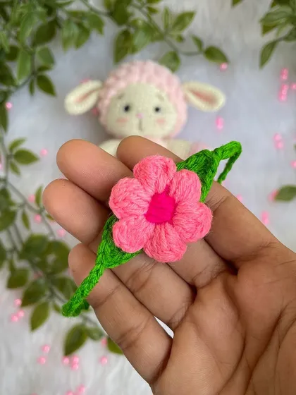 A close-up of a pretty pink flower I made as an accessory for a little crochet lamb. It shows how my flowers can be used to customize other handmade items.