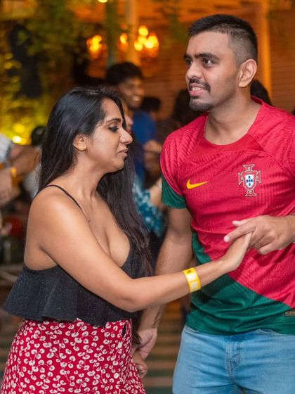 Even in a football jersey, the salsa spirit is strong. Our students bring their passion everywhere, including the social dance floor.