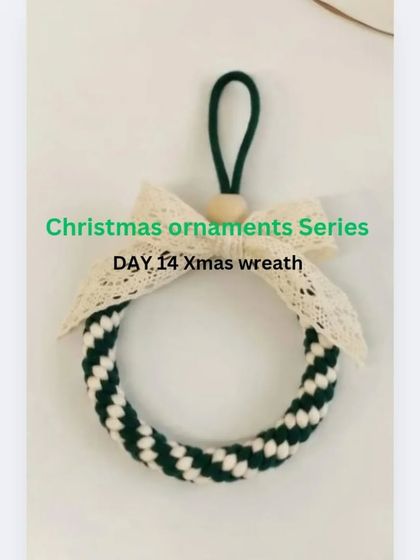 My handmade macrame Christmas wreath ornament. This design uses a crown knot to create a lovely striped pattern, finished with a delicate lace bow.