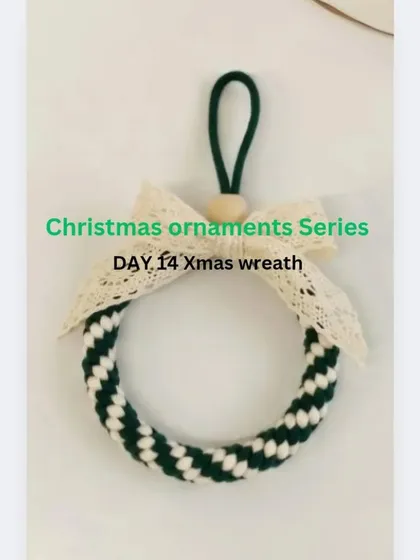 My handmade macrame Christmas wreath ornament. This design uses a crown knot to create a lovely striped pattern, finished with a delicate lace bow.