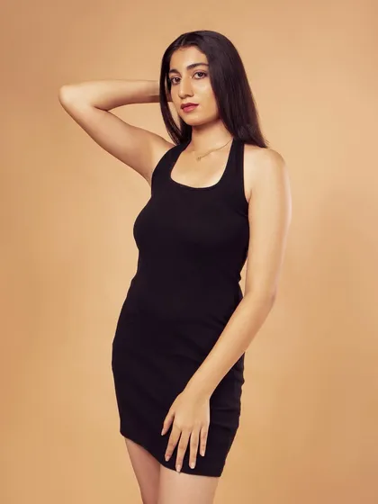 A classic fashion pose, showing off the silhouette of the dress.