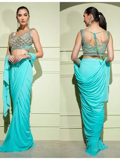 A front and back view of the vibrant turquoise drape saree. The intricate embroidery on the blouse and the unique draping at the back make it a standout piece.