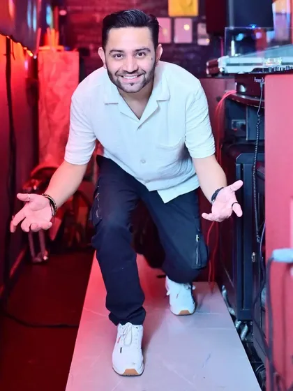 Welcoming everyone to the party from my spot in the DJ booth.