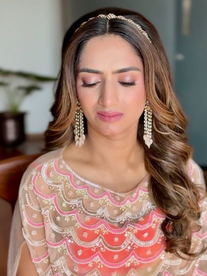 Dainty beauty and soft hues. This look is perfect for a bride or bridesmaid, featuring soft pink makeup and a simple, elegant headband.