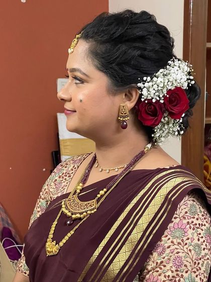 Swathi wanted a very natural look for her Varpooja, and she loved the result. I used minimal makeup to enhance her features, paired with a soft, romantic hairstyle with fresh roses.