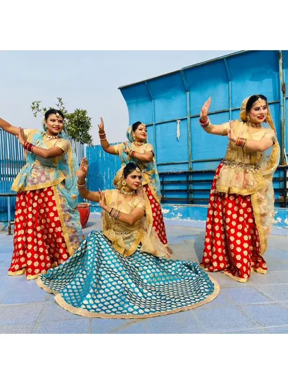 Our folk dance troupe in a dynamic pose. We choreograph group performances that are visually stunning and full of cultural richness.