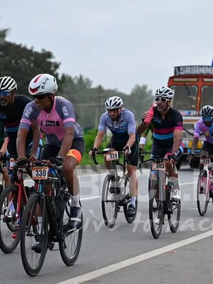 The masters peloton, with a support truck in the background, highlighting the logistical support we provide for a safe race.