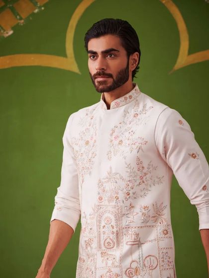 A portrait of the model in the white kurta set, highlighting the intricate embroidery on the waistcoat. This is a perfect example of the grace and sophistication of the Nazaakat collection.