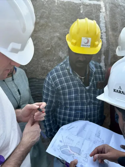 Our team marking cutouts on the main boulder at the Lurra House site. This intricate process involves translating our 2D drawings onto the 3D form of the natural rock.