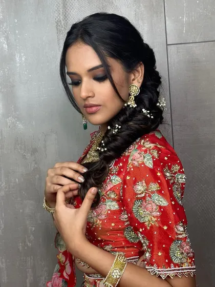 A closer look at this Mehendi hairstyle. I created a soft, romantic braid and wove in delicate baby's breath for a touch of ethereal beauty.