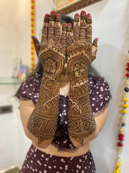 The back of a bridal mehendi design, showing the full coverage and intricate patterns. This is a perfect example of a traditional bridal look.