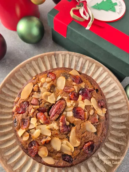 My traditional boozy Plum Cake for Christmas. It's rich, moist, and packed with rum-soaked fruits and nuts like pecans and almonds, presented in a festive gift box.