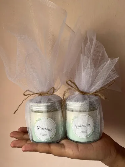 Our silver lid jar candles, wrapped in net with a jute string. They are a perfect, eco-friendly gift.