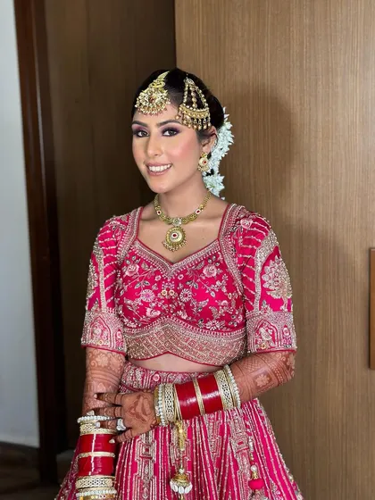 Ashmeet's radiant smile says it all. I love creating looks that give my brides that extra boost of confidence on their special day.