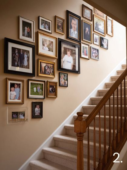 Let your staircase tell your family's story. This classic arrangement uses a mix of ornate gold and traditional dark wood frames to display family portraits and milestones, creating a warm and timeless journey as you walk up the stairs.