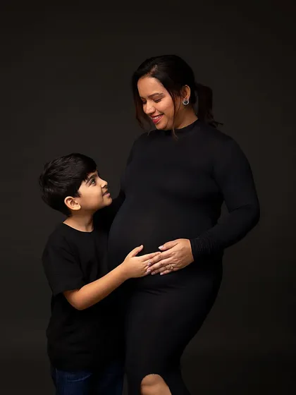 A color version of the mother and son, showing their warm interaction and the beautiful shape of her pregnancy.