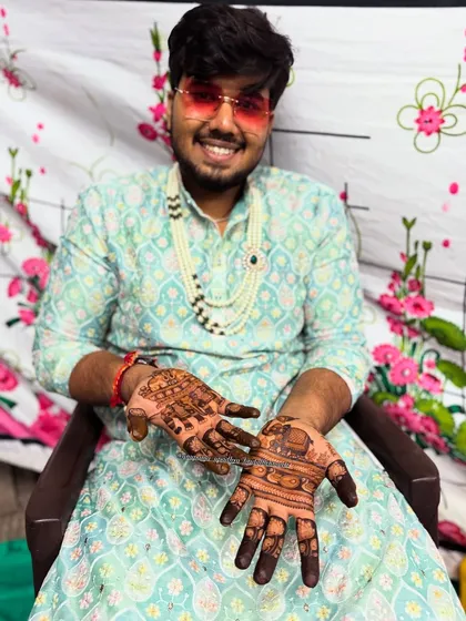 A happy groom ready for his wedding. His hands carry the elegance of peacocks and the strength of elephants, traditional symbols for a new journey.